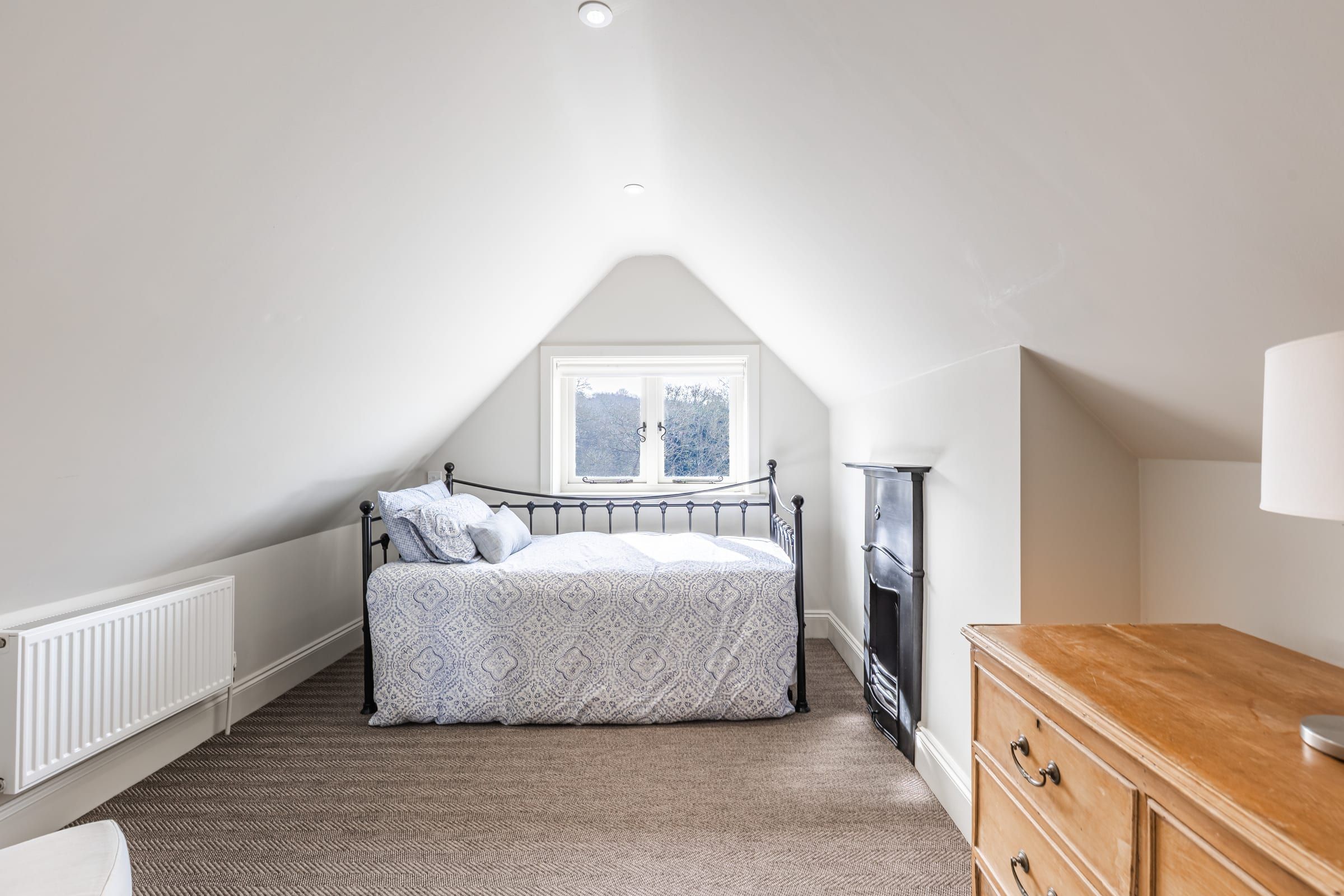 A first-floor bedroom with original fireplace